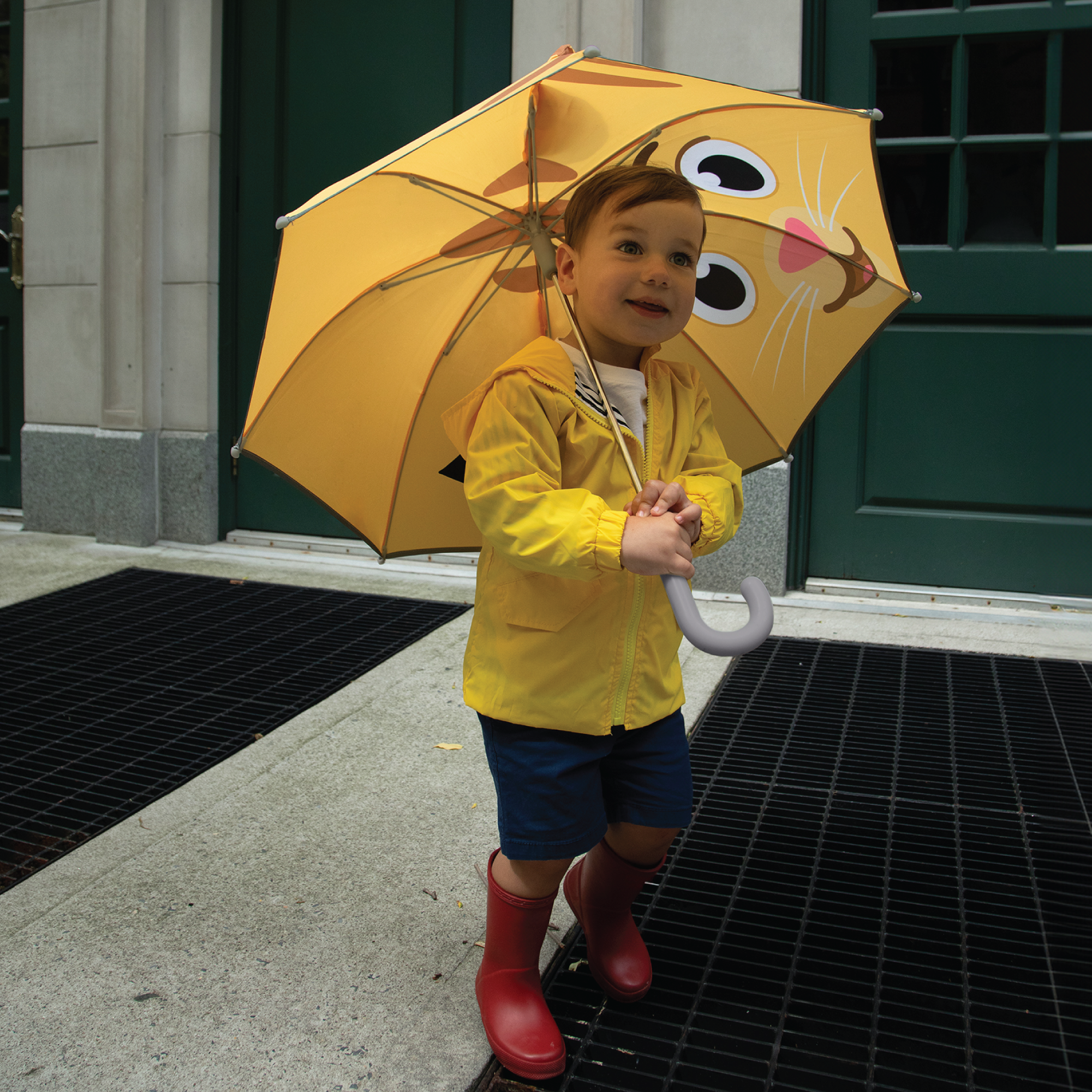 Young child walking with Daniel Tiger's Neighborhood Kids Umbrella.