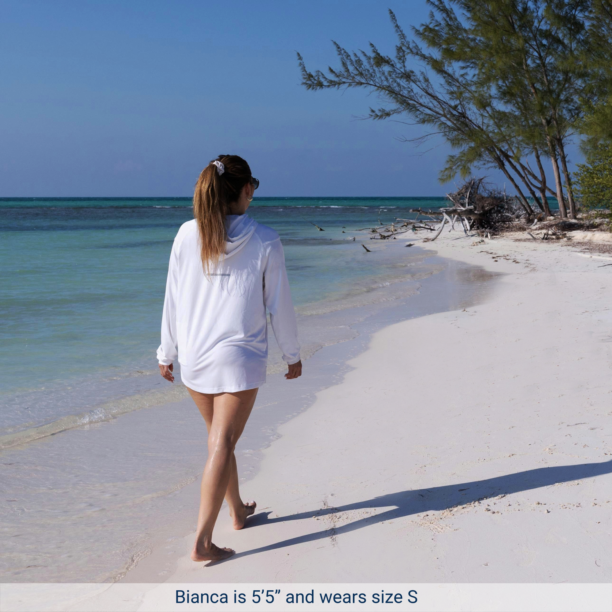 Woman walking beach wearing Weatherman UPF 50+ UV Protection Sun Shirt in white size small.